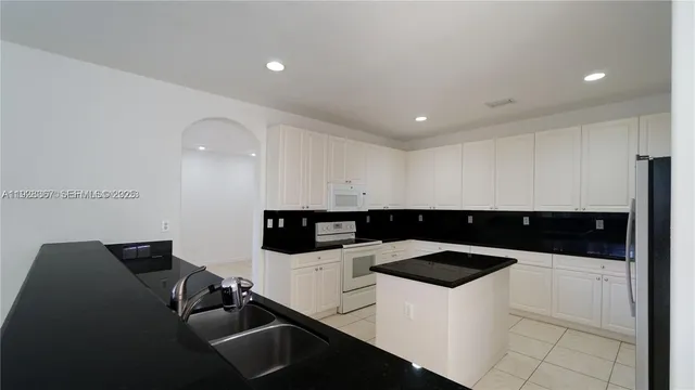 a view of a kitchen with furniture and an empty space