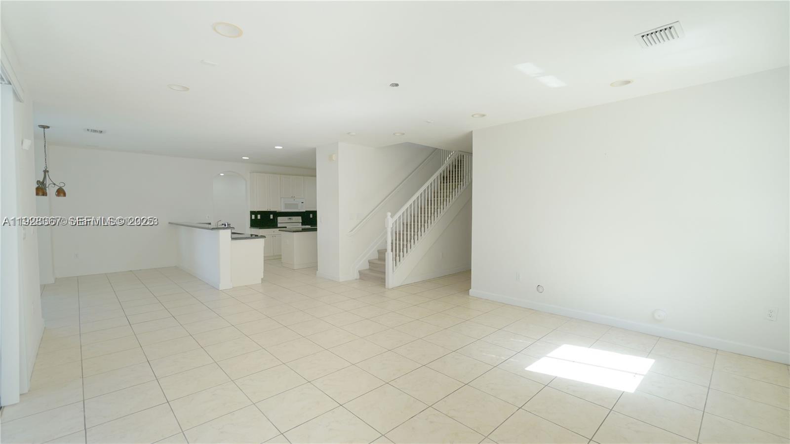 7507 Southwest 189th Street, Unit 7507 Cutler Bay, FL 33157 - Photo 14 of 28 a view of a kitchen with furniture and an empty space