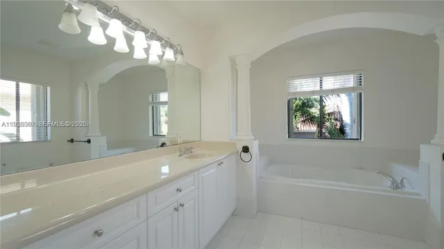 a bathroom with a double vanity sink and mirror