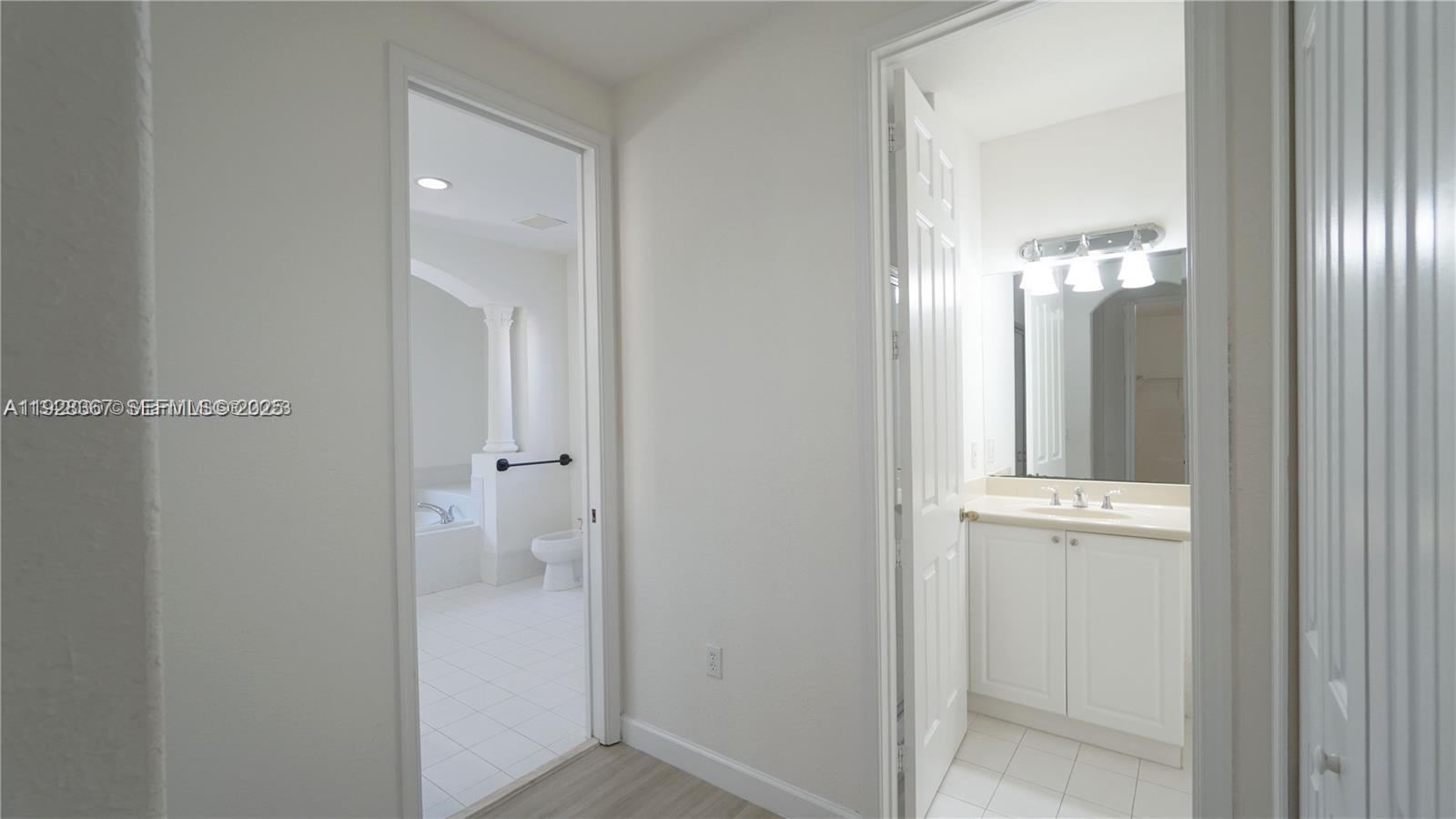 7507 Southwest 189th Street, Unit 7507 Cutler Bay, FL 33157 - Photo 21 of 28 wooden floor with a mirror