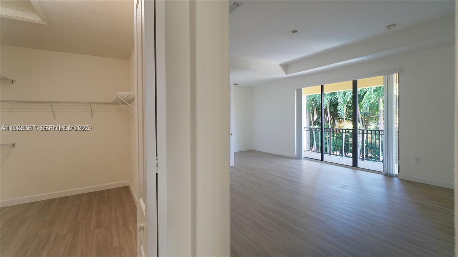 7507 Southwest 189th Street, Unit 7507 Cutler Bay, FL 33157 - Photo 22 of 28 wooden floor in an empty room with a window
