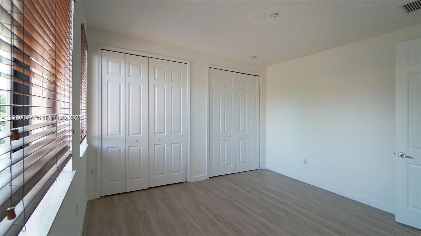 7507 Southwest 189th Street, Unit 7507 Cutler Bay, FL 33157 - Photo 27 of 28 a view of a room with wooden floor
