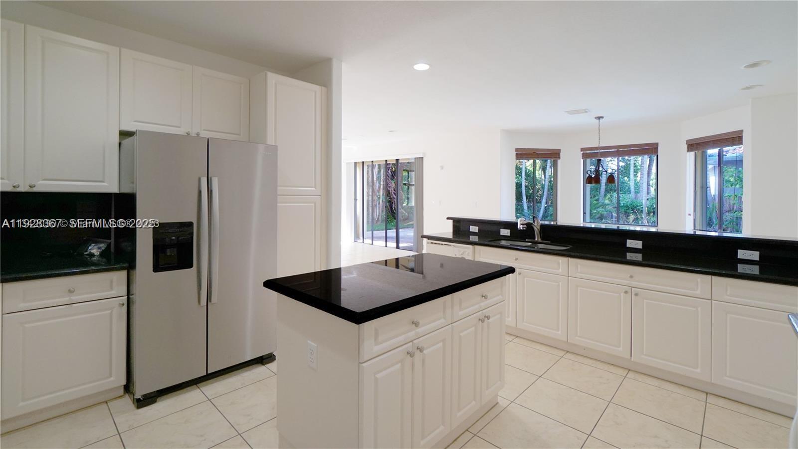 7507 Southwest 189th Street, Unit 7507 Cutler Bay, FL 33157 - Photo 10 of 28 a kitchen with a sink and refrigerator