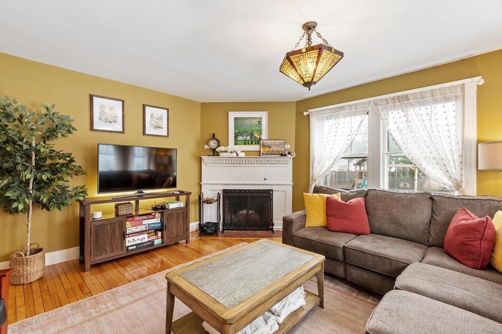 20 Shattuck Street Littleton, MA 01460 - Photo 15 of 41 a living room with furniture a flat screen tv and a fireplace