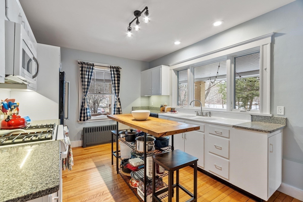 20 Shattuck Street Littleton, MA 01460 - Photo 16 of 41 a kitchen with a stove a sink dishwasher and a refrigerator with wooden floor