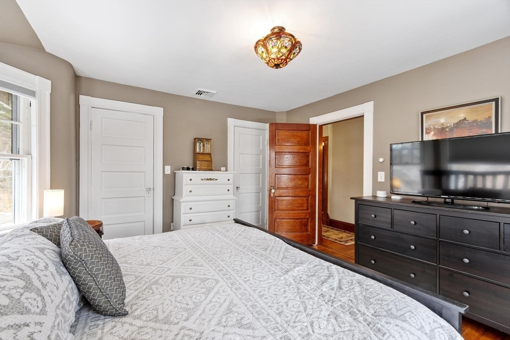 20 Shattuck Street Littleton, MA 01460 - Photo 27 of 41 a bedroom with a bed and a flat screen tv
