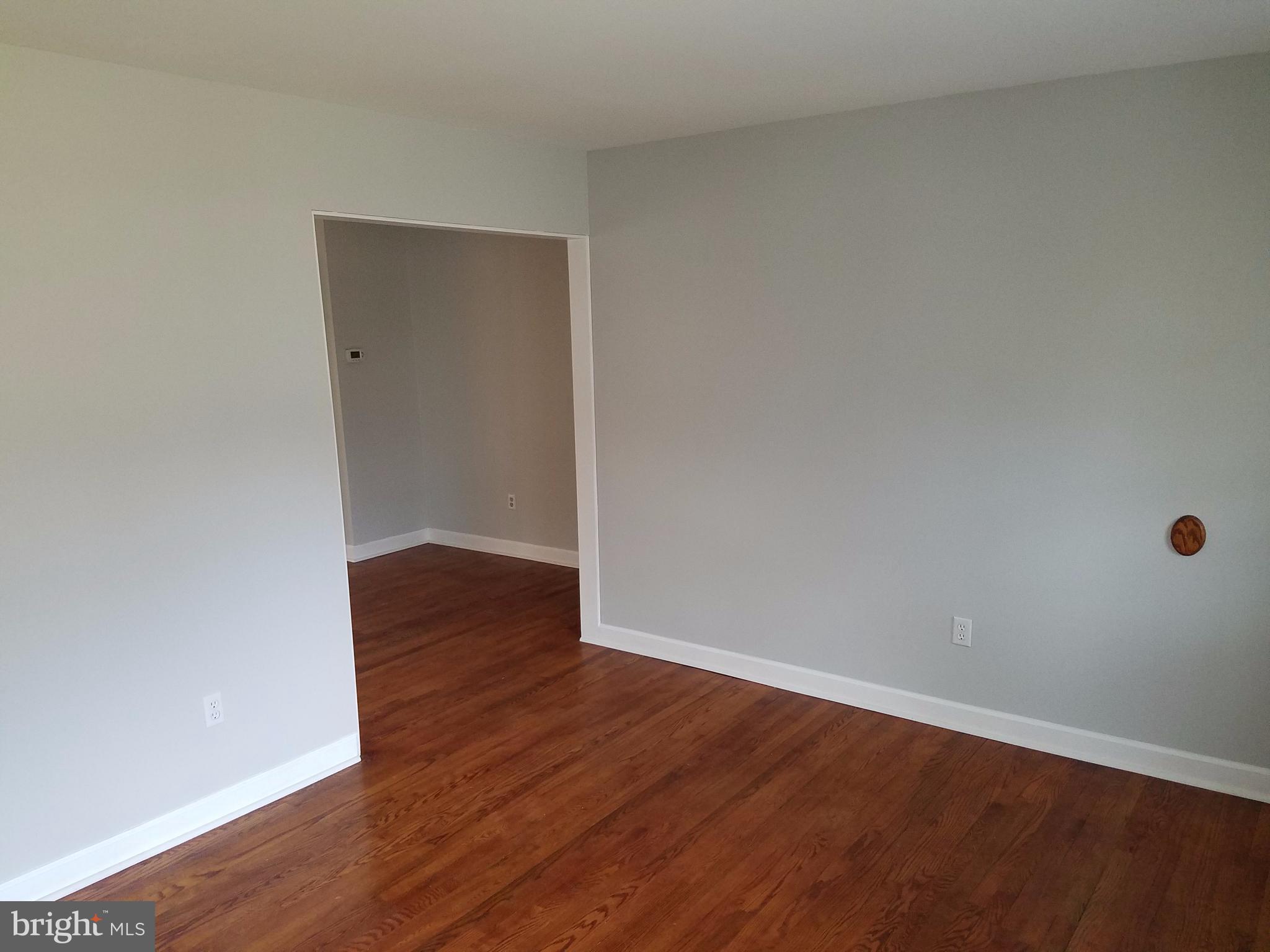 1335 Ava Road Severn, MD 21144 - Photo 3 of 13 a view of an empty room with wooden floor