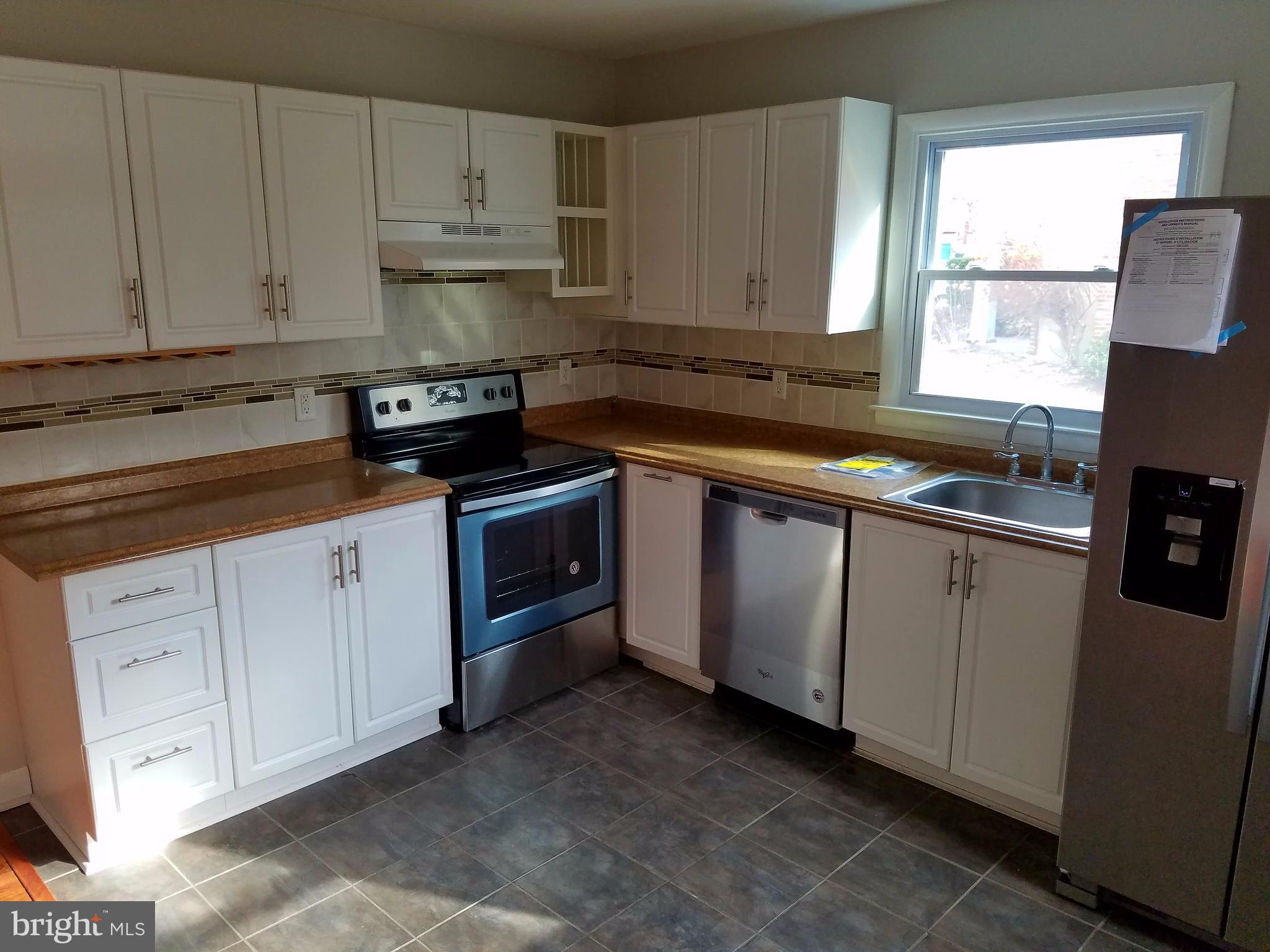 1335 Ava Road Severn, MD 21144 - Photo 4 of 13 a kitchen with granite countertop white cabinets and white appliances