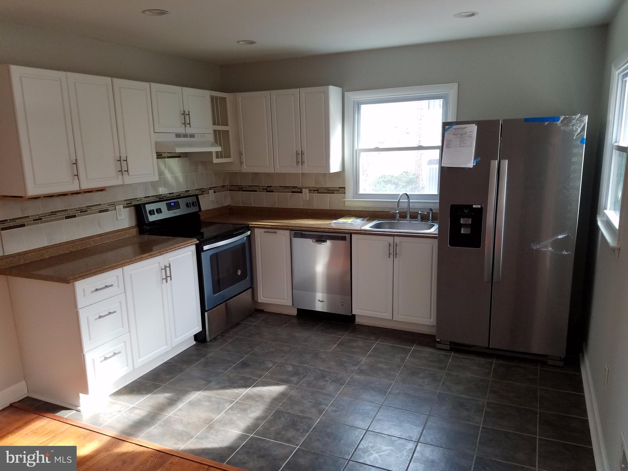 1335 Ava Road Severn, MD 21144 - Photo 5 of 13 a kitchen with granite countertop a refrigerator sink and cabinets