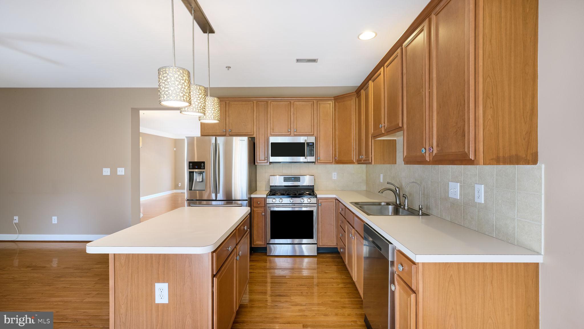 2372 Dorchester Street West, Unit W Furlong, PA 18925 - Photo 18 of 41 a kitchen with stainless steel appliances a stove refrigerator sink and microwave