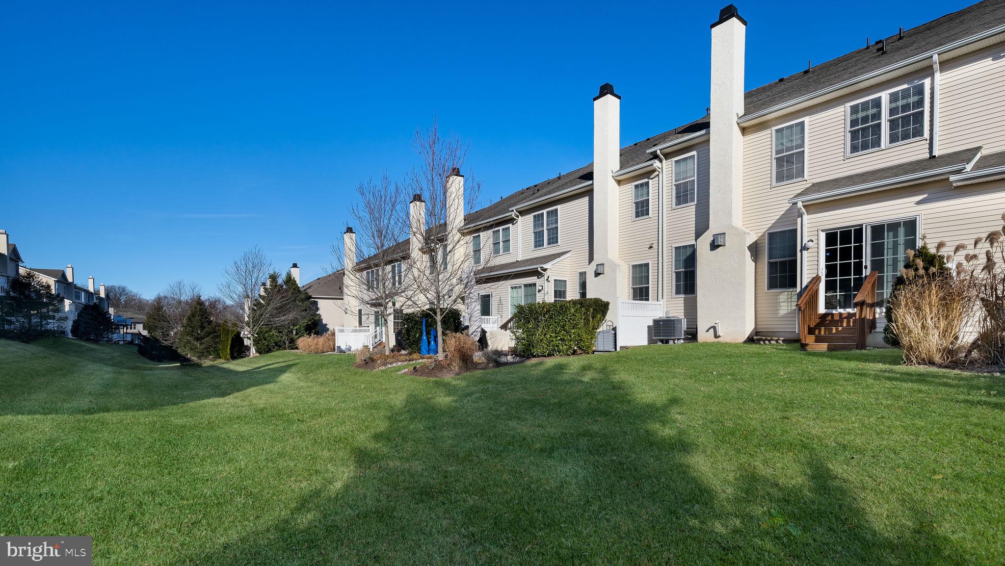 2372 Dorchester Street West, Unit W Furlong, PA 18925 - Photo 41 of 41 a view of a white house with a big yard and large trees