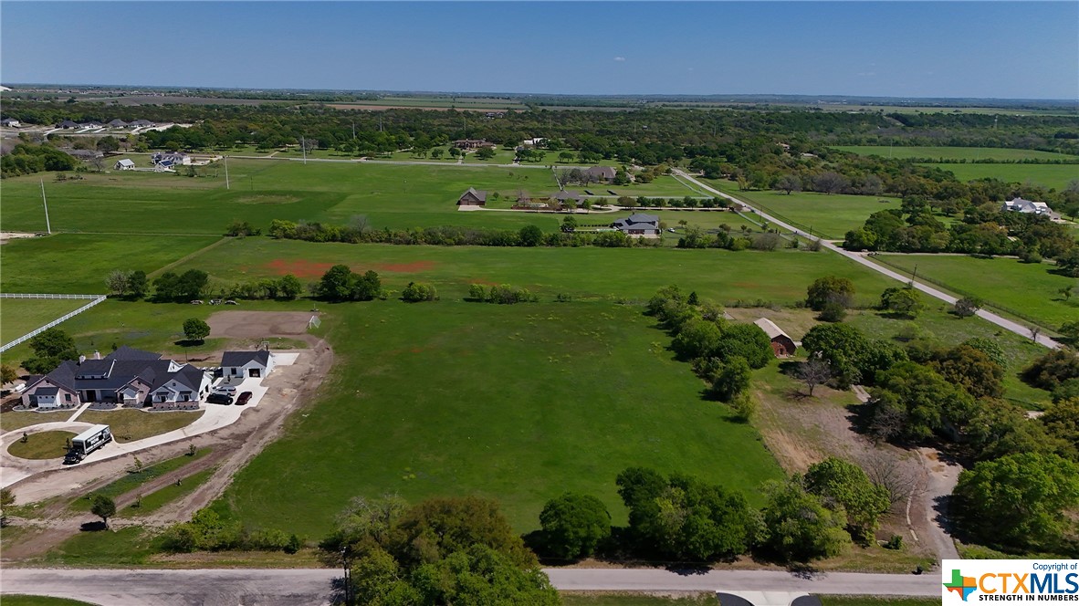 an aerial view of a city with lots of residential buildings and mountain view in back