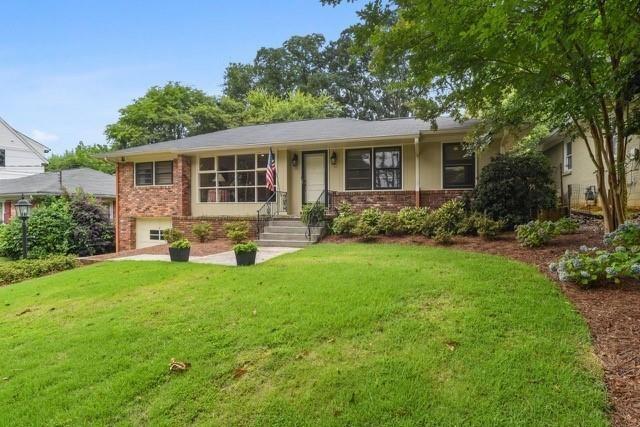 a front view of house with yard and green space