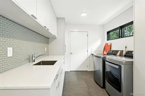 a bathroom with a sink and a washer dryer