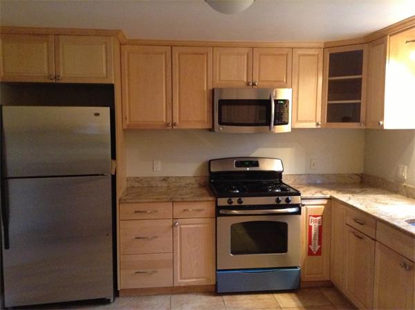 55 High Street Needham, MA 02494 - Photo 5 of 15 a kitchen with cabinets stainless steel appliances and a window