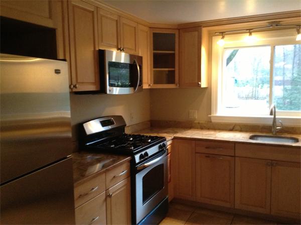 55 High Street Needham, MA 02494 - Photo 7 of 15 a kitchen with stainless steel appliances a sink stove and microwave