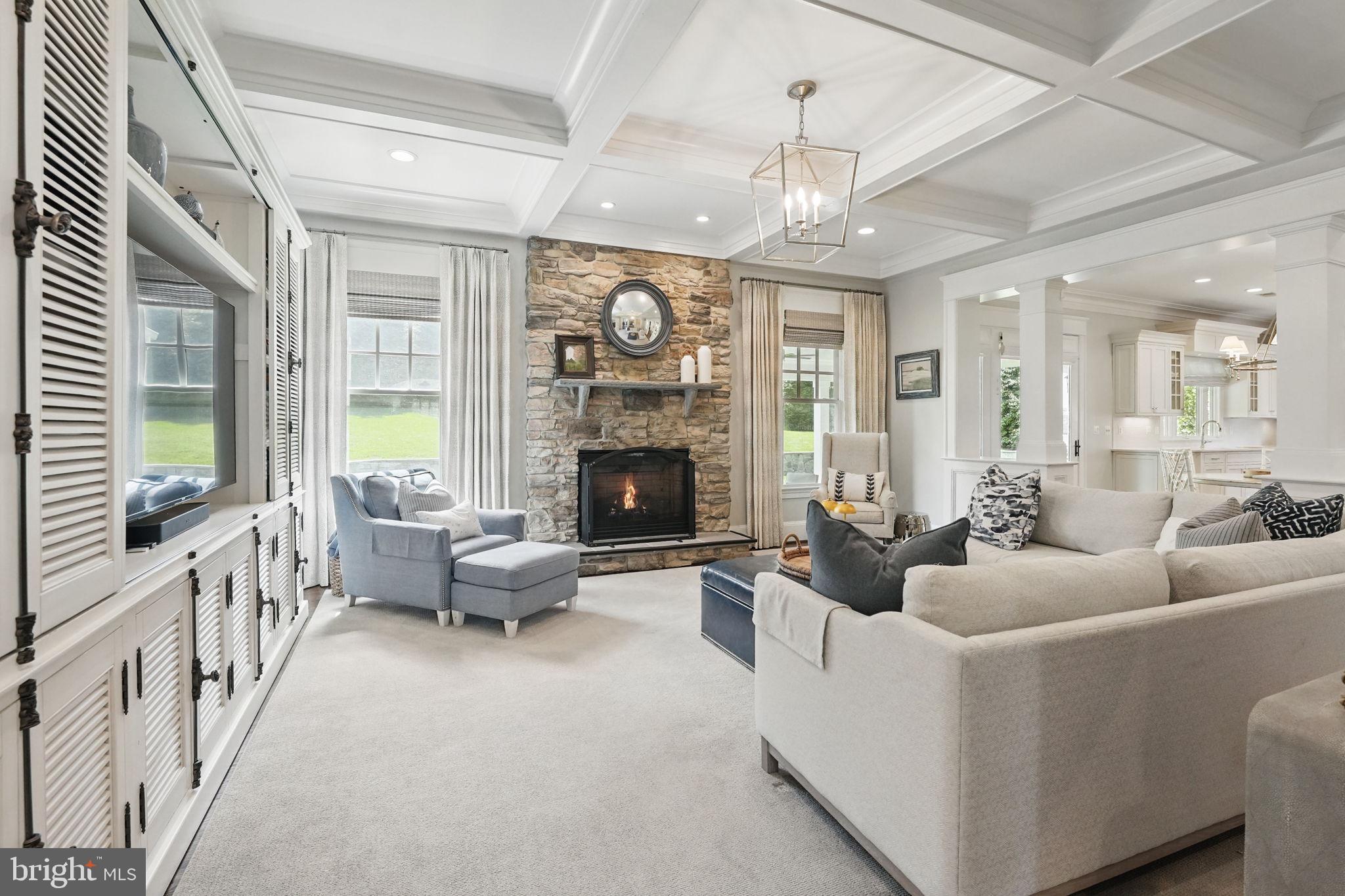 6645 Byrns Place McLean, VA 22101 - Photo 15 of 64 a living room with furniture a fireplace and a chandelier