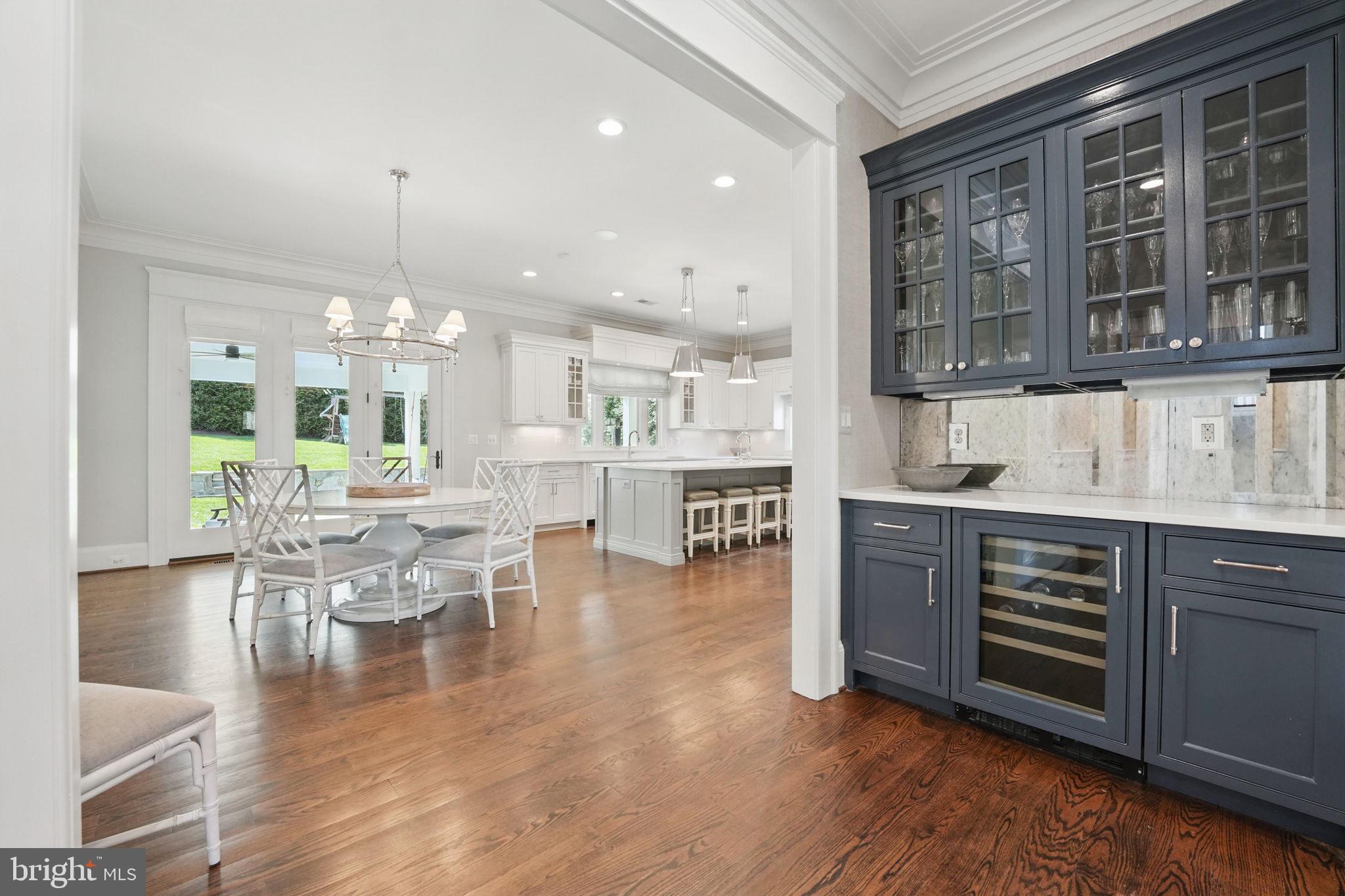 6645 Byrns Place McLean, VA 22101 - Photo 17 of 64 a kitchen with stainless steel appliances granite countertop a stove top oven a dining table and chairs with wooden floor