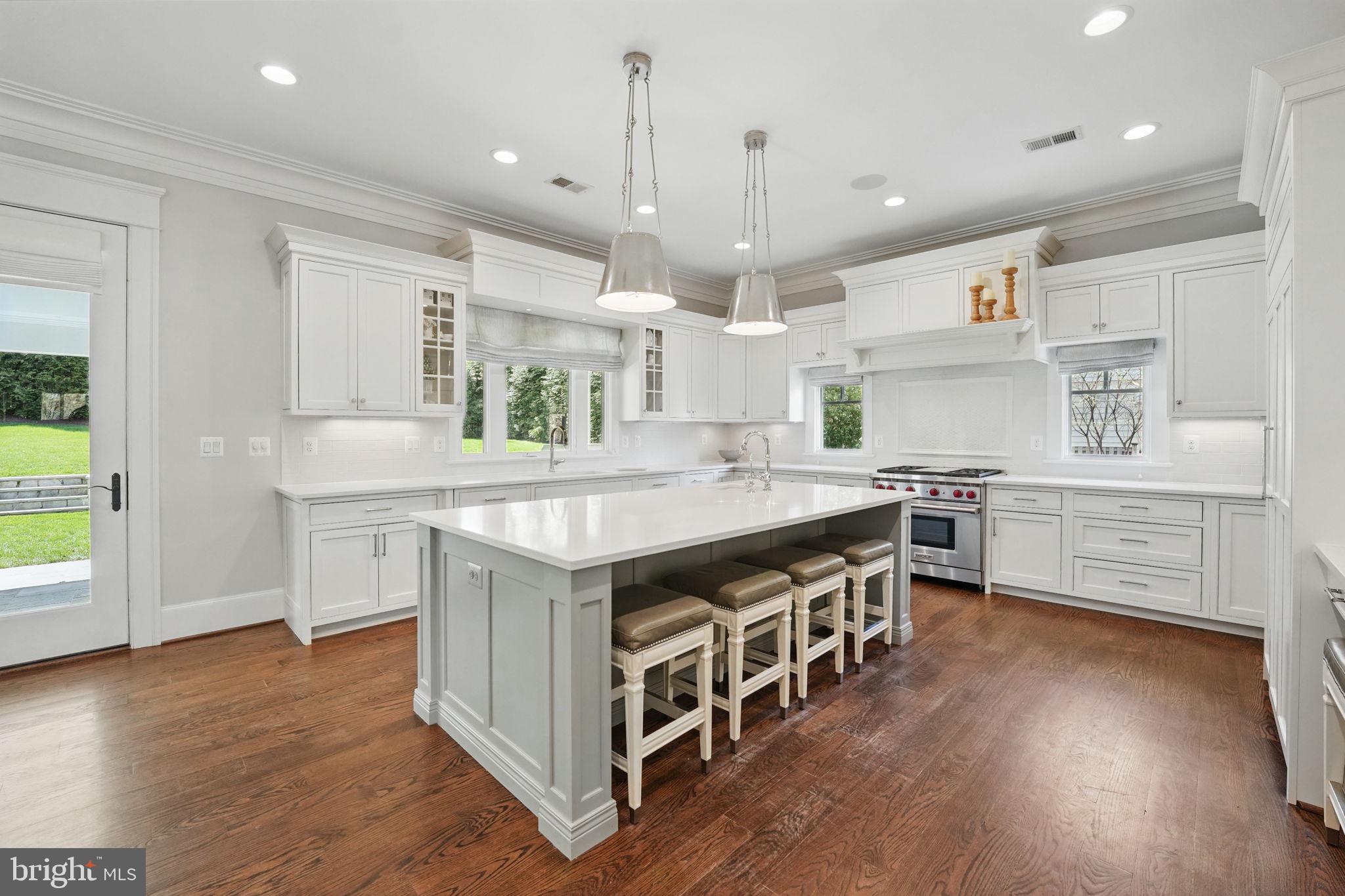 6645 Byrns Place McLean, VA 22101 - Photo 20 of 64 a kitchen with stainless steel appliances a sink stove and wooden floor