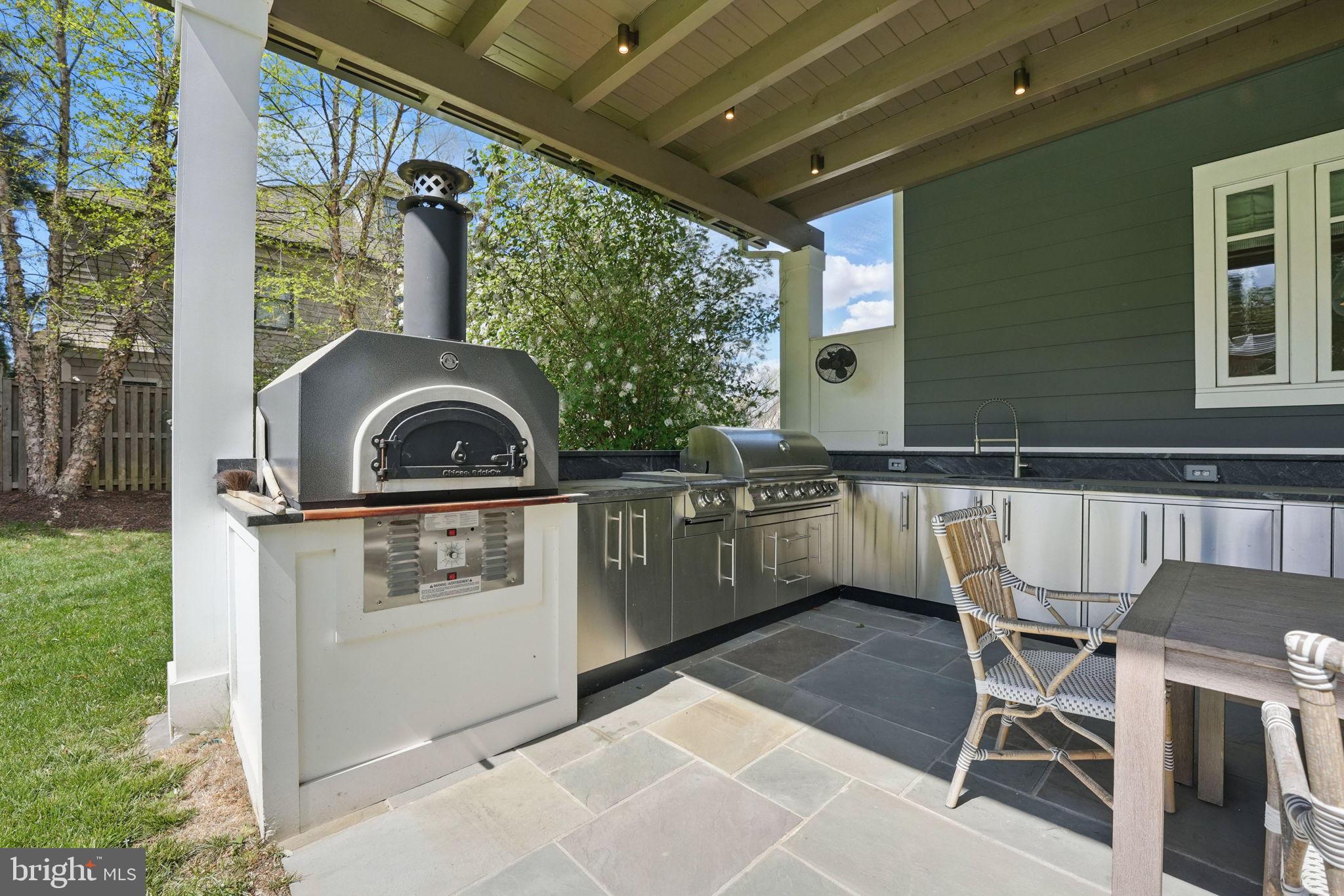 6645 Byrns Place McLean, VA 22101 - Photo 28 of 64 a kitchen with a stove a table and chairs