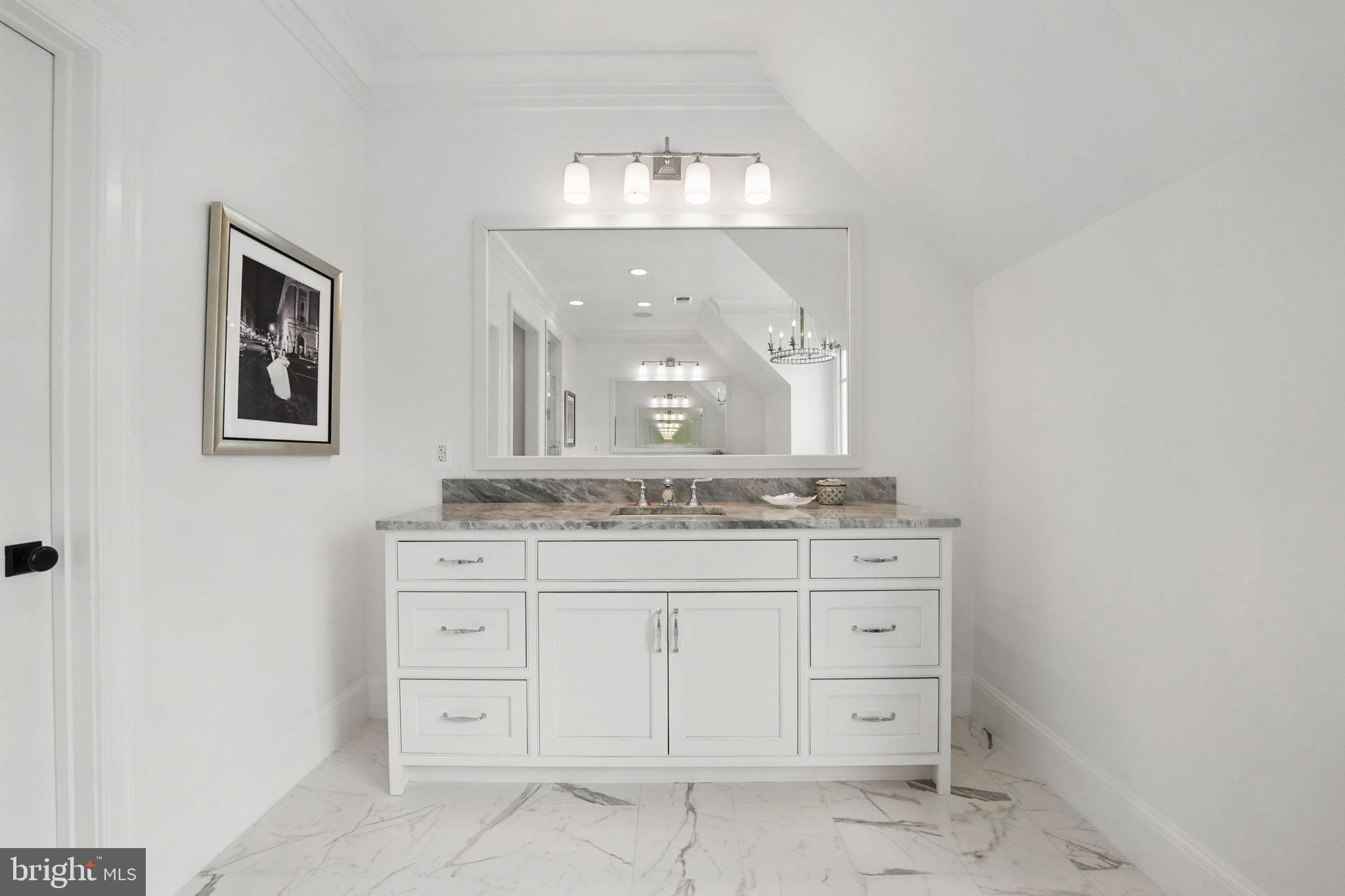 6645 Byrns Place McLean, VA 22101 - Photo 35 of 64 a bathroom with a granite countertop sink a mirror and a vanity