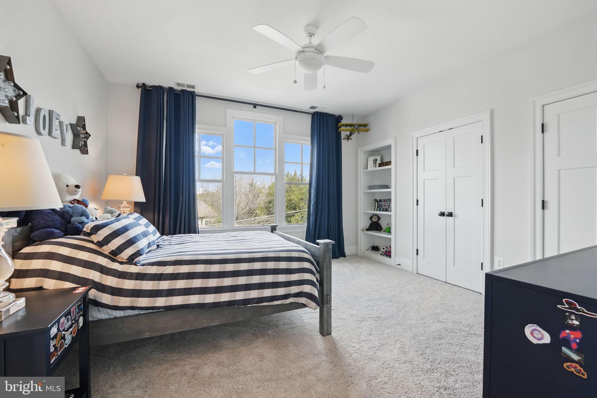 6645 Byrns Place McLean, VA 22101 - Photo 39 of 64 a bedroom with a bed and a chandelier