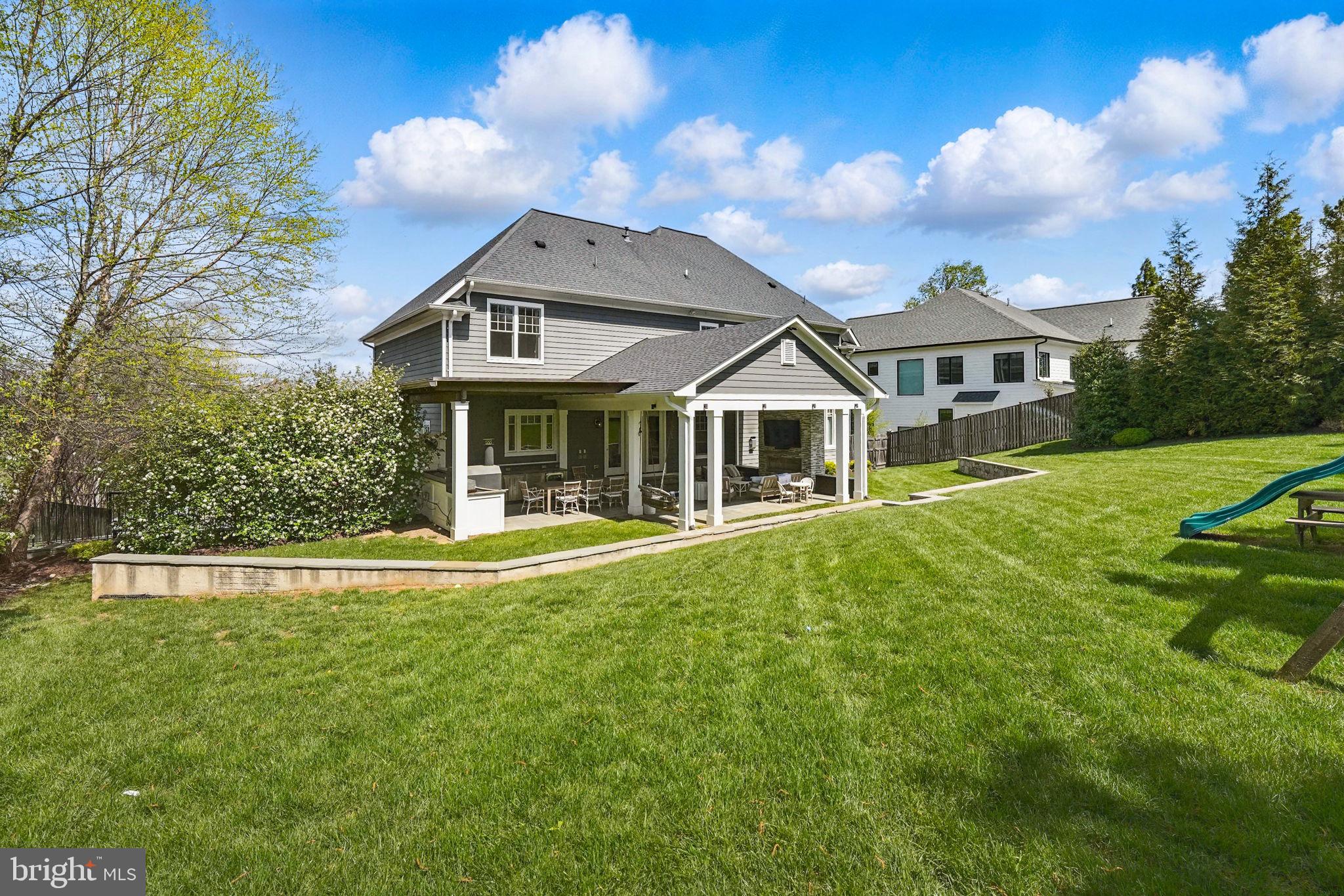 6645 Byrns Place McLean, VA 22101 - Photo 63 of 64 a front view of a house with a yard table and chairs