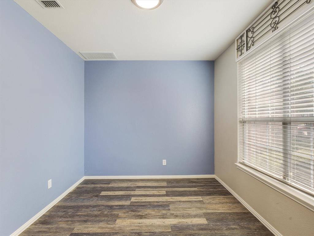 2009 Cooper Ridge Lane Heartland, TX 75126 - Photo 5 of 40 a view of an empty room with wooden floor and a window