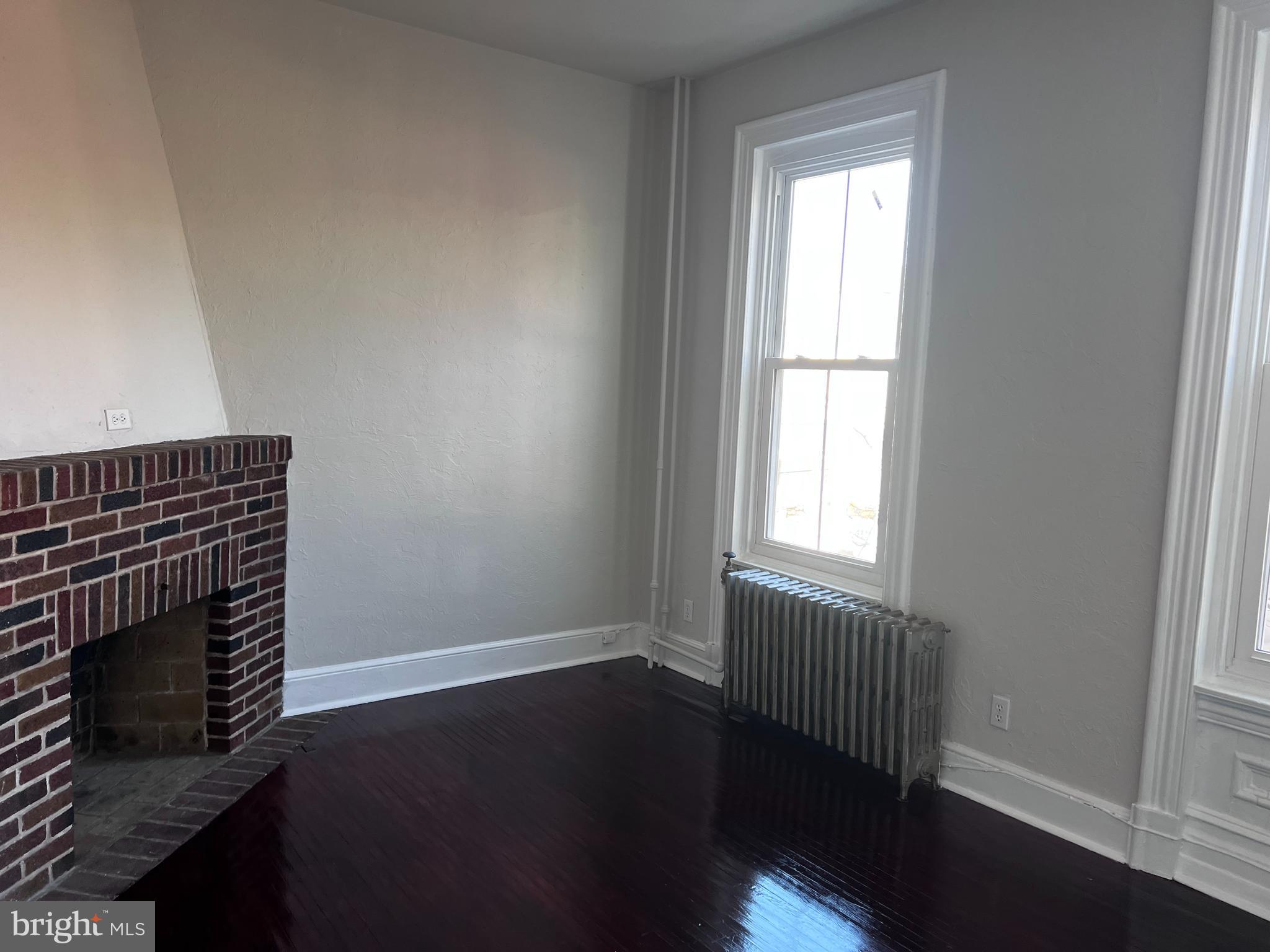 104 King Street, Unit 2F Pottstown, PA 19464 - Photo 2 of 7 a view of an empty room with wooden floor and a window