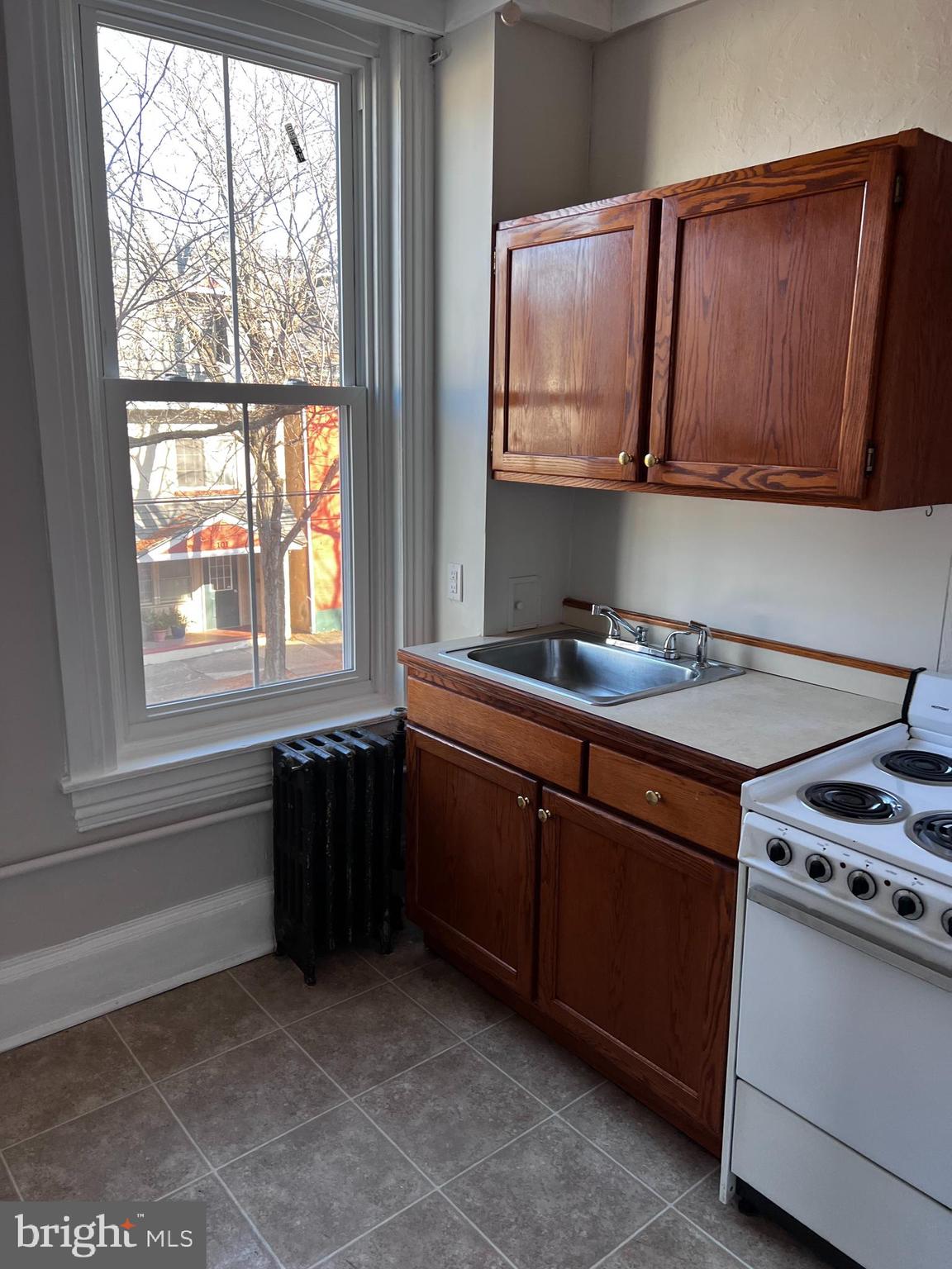 104 King Street, Unit 2F Pottstown, PA 19464 - Photo 4 of 7 a kitchen with stainless steel appliances granite countertop a sink stove and microwave