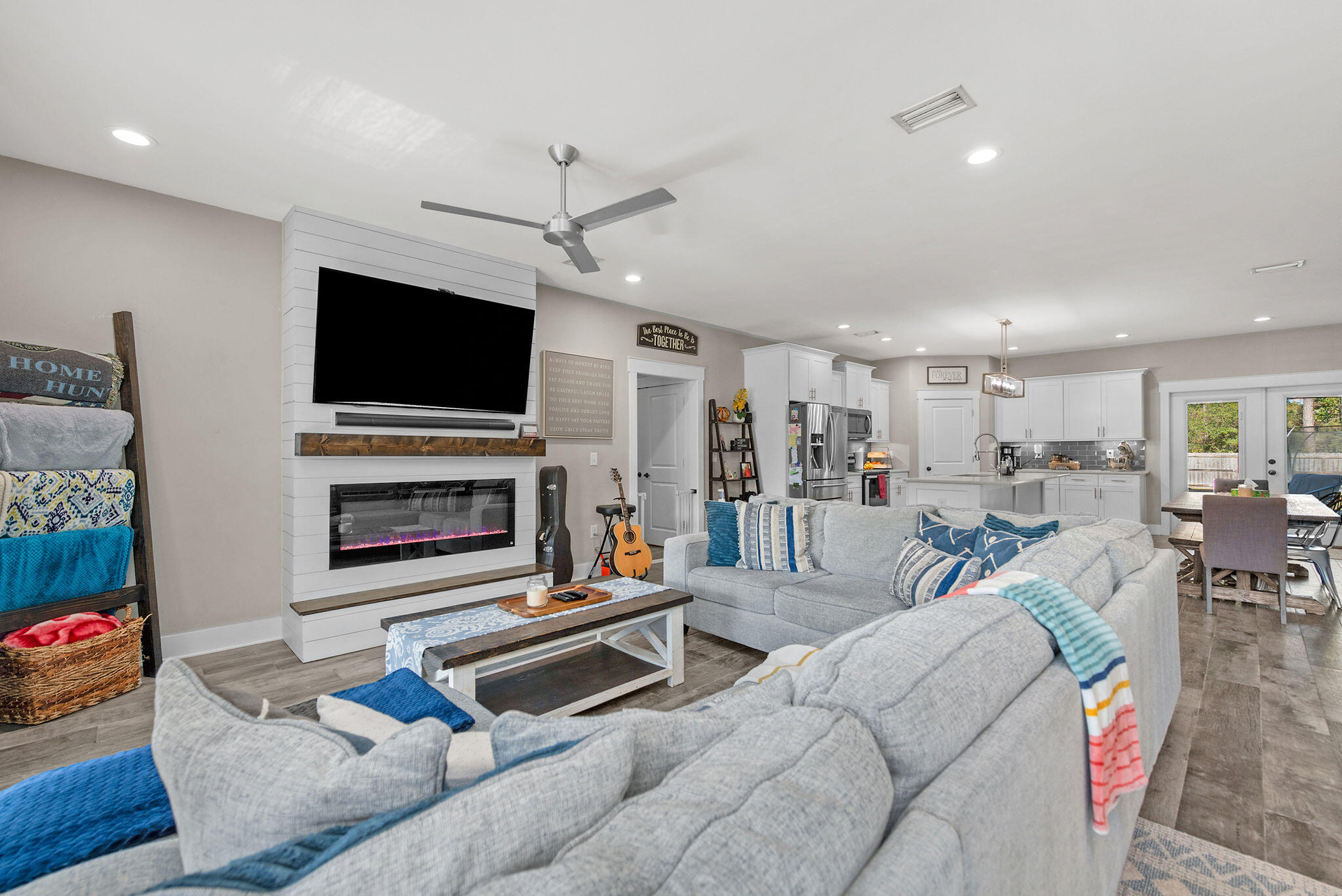 8914 Timber Lane Navarre, FL 32566 - Photo 8 of 40 a living room with furniture a flat screen tv and a fireplace