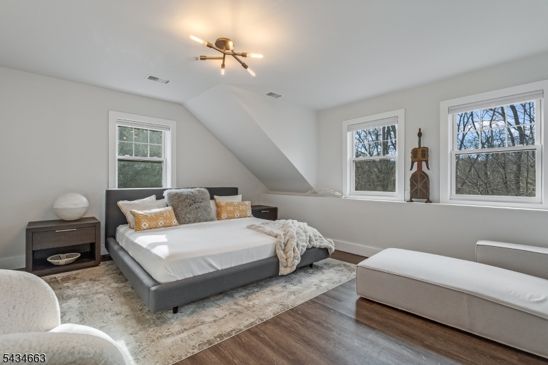55 State Park Road Chester, NJ 07930 - Photo 35 of 48 a bedroom with a bed and wooden floor