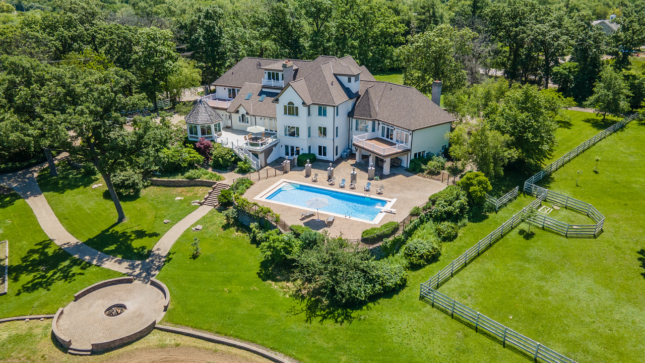 an aerial view of a house with yard swimming pool and outdoor seating