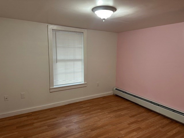 34 Perkins Street, Unit 1 Gloucester, MA 01930 - Photo 11 of 14 an empty room with wooden floor and windows