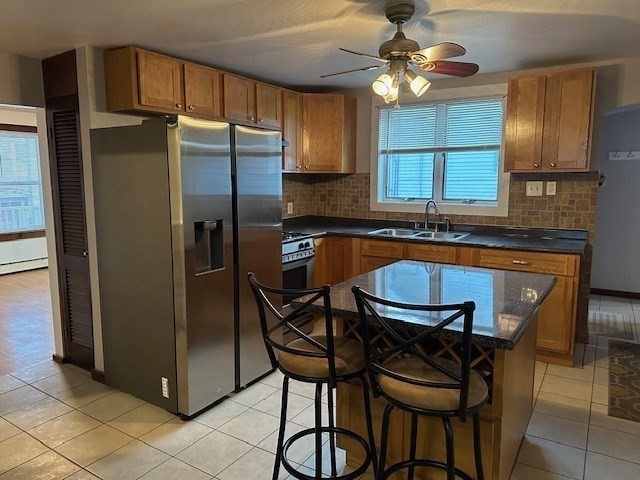 34 Perkins Street, Unit 1 Gloucester, MA 01930 - Photo 2 of 14 a kitchen with stainless steel appliances granite countertop a refrigerator a stove a sink and a microwave