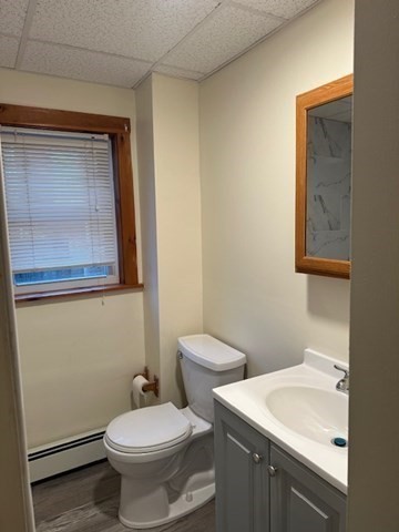 34 Perkins Street, Unit 1 Gloucester, MA 01930 - Photo 5 of 14 a bathroom with a toilet sink and mirror