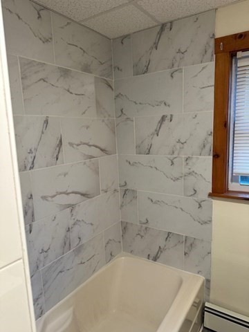 34 Perkins Street, Unit 1 Gloucester, MA 01930 - Photo 7 of 14 a bathroom with a bathtub and shower