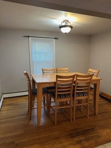 34 Perkins Street, Unit 1 Gloucester, MA 01930 - Photo 9 of 14 a view of a dining room with furniture and wooden floor