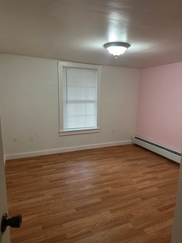 34 Perkins Street, Unit 1 Gloucester, MA 01930 - Photo 10 of 14 an empty room with wooden floor and windows