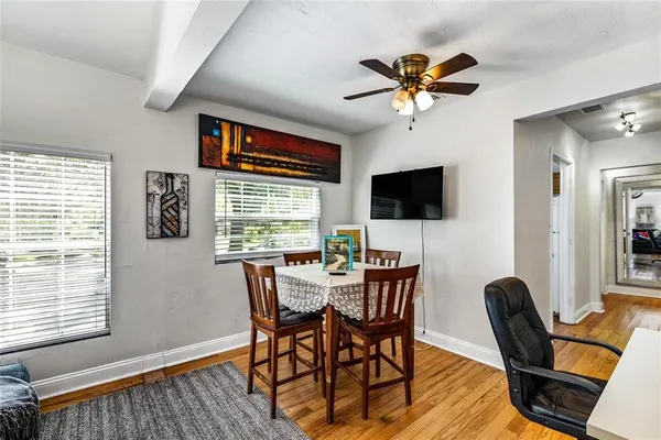 a view of a dining room with furniture window and wooden floor