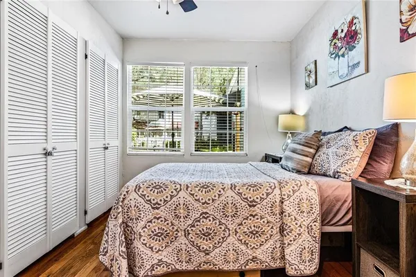 a bedroom with a bed and a large window