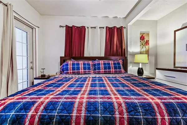 a bedroom with a bed and a window