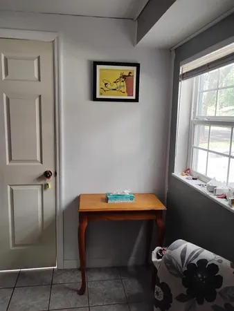 a room with a bed and windows