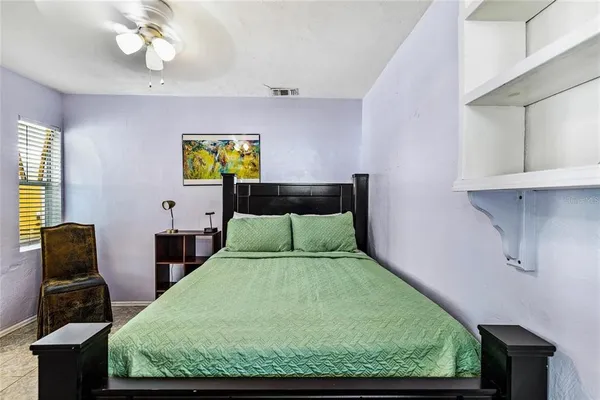 a bedroom with a bed and window