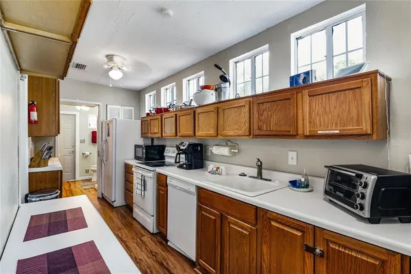 a kitchen with stainless steel appliances granite countertop a sink a stove and cabinets