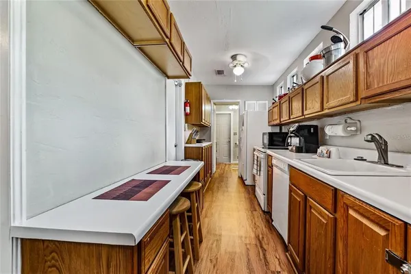 a kitchen with stainless steel appliances granite countertop a sink and wooden cabinets