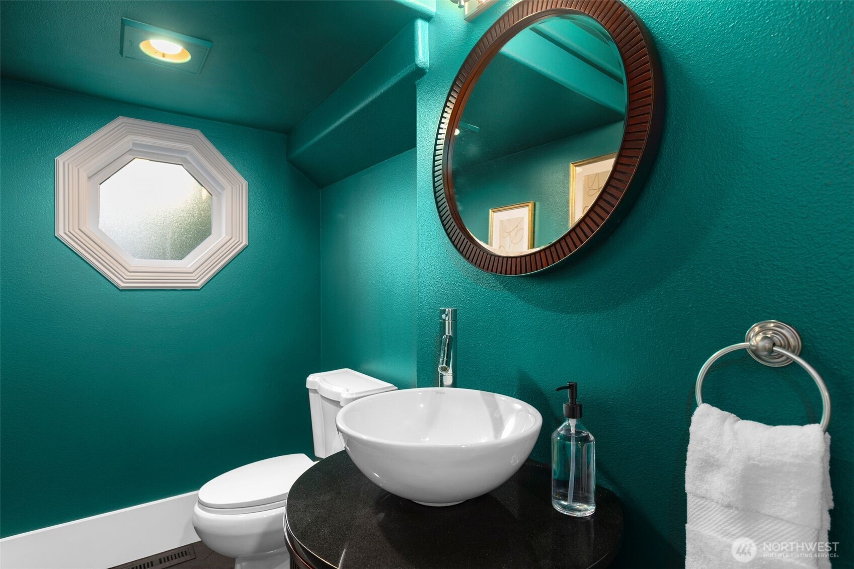 1147 Federal Avenue East Seattle, WA 98102 - Photo 15 of 40 a bathroom with a toilet mirror and vanity