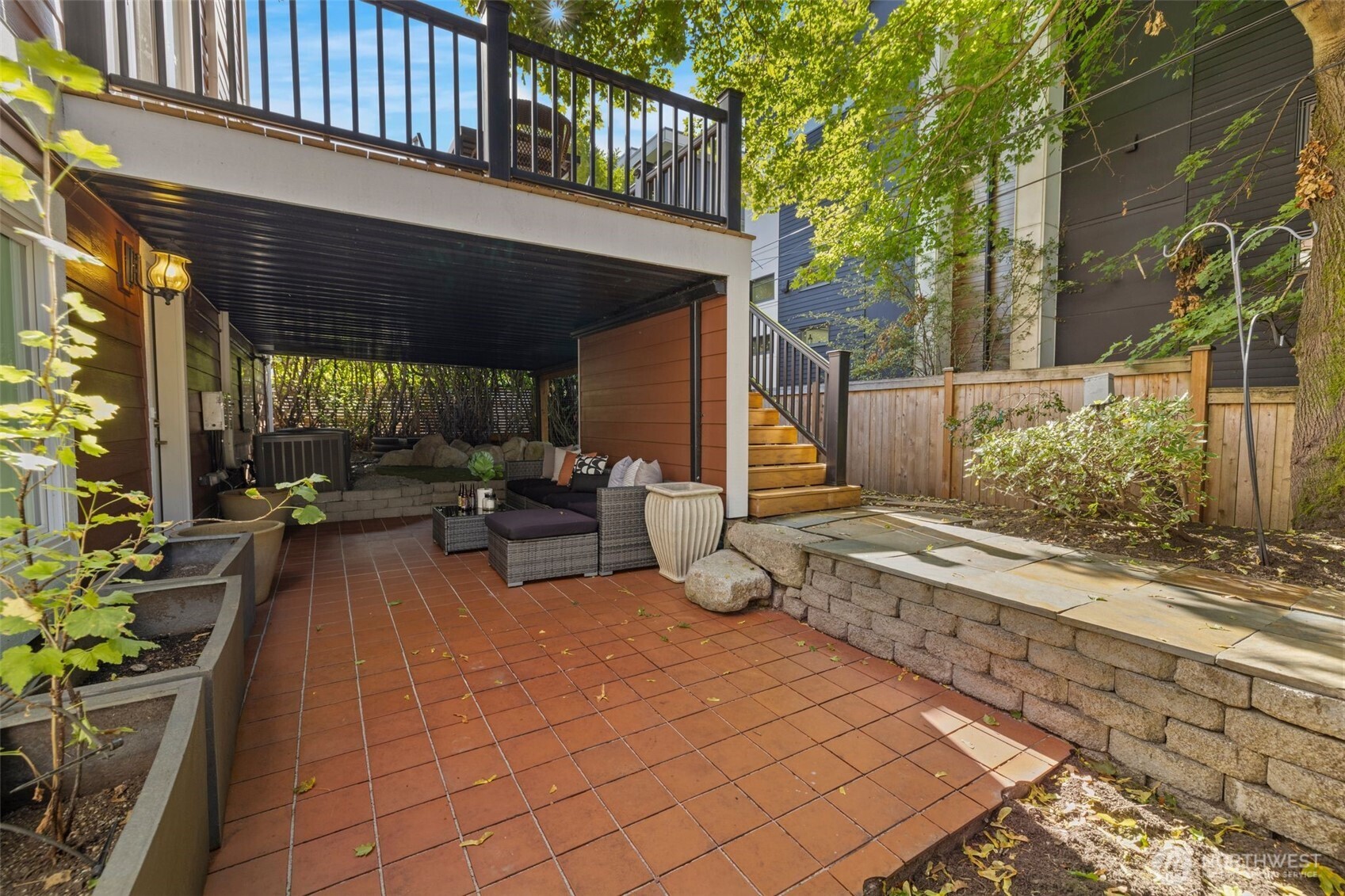 1147 Federal Avenue East Seattle, WA 98102 - Photo 37 of 40 a view of a patio with table and chairs potted plants and large tree