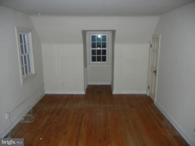 111 Homewood Road Linthicum Heights, MD 21090 - Photo 13 of 14 a view of an empty room with wooden floor and a window