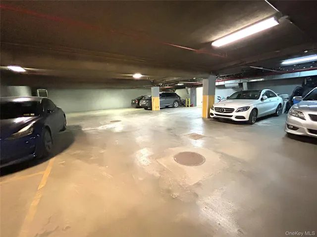 a view of parking garage with cars parked